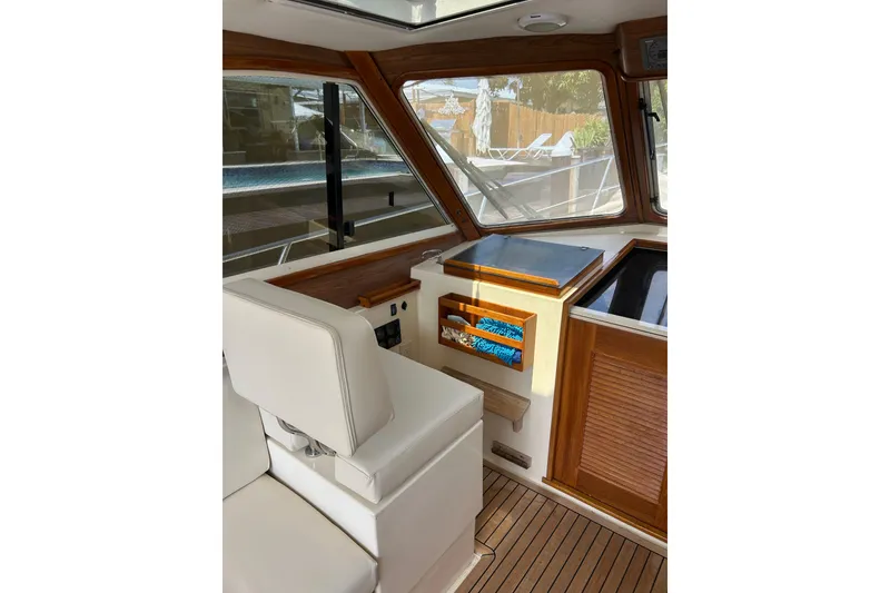 Slide: The Image of Interior of 2007 Legacy EXPRESS CRUISER with wood accents and white seating. - 8