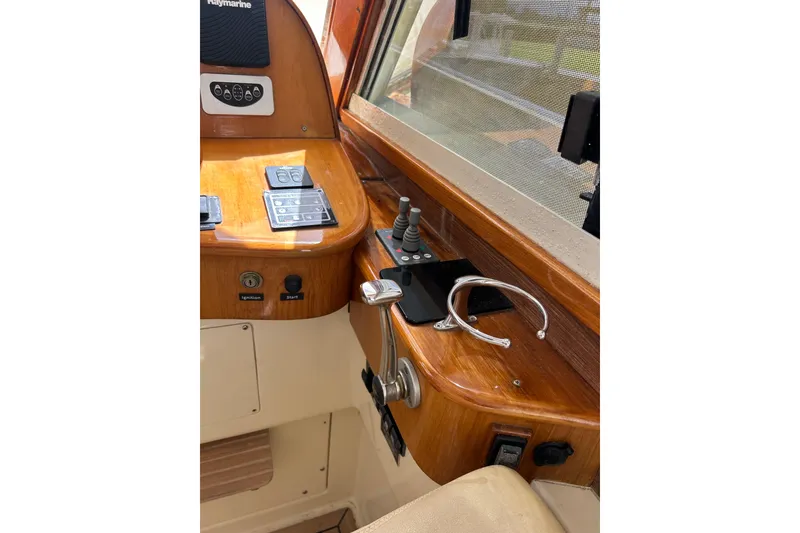 Slide: The Image of Control panel of a 2007 Legacy EXPRESS CRUISER with wooden finish and navigation equipment. - 16