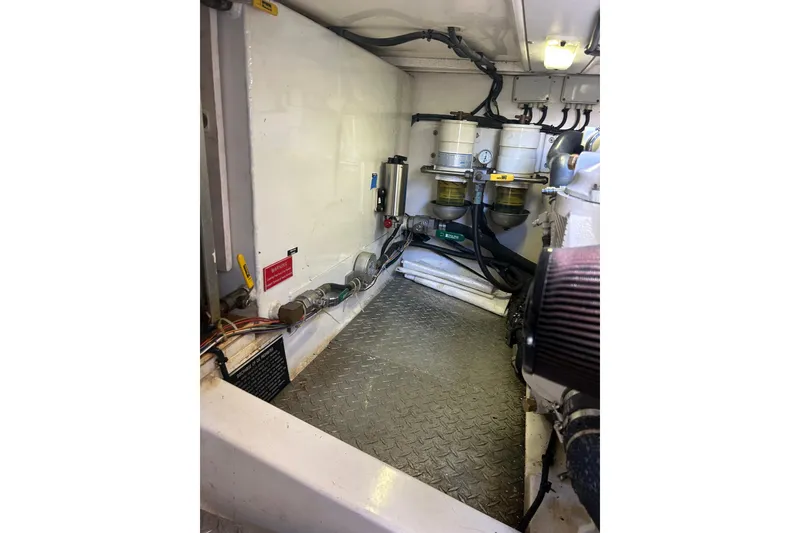 Slide: The Image of Engine room of 2007 Legacy EXPRESS CRUISER with visible fuel filters and wiring. - 33