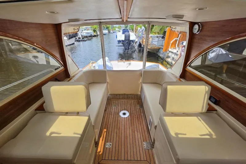 Slide: The Image of Interior of 2007 Legacy EXPRESS CRUISER with beige seating and wooden flooring. - 2