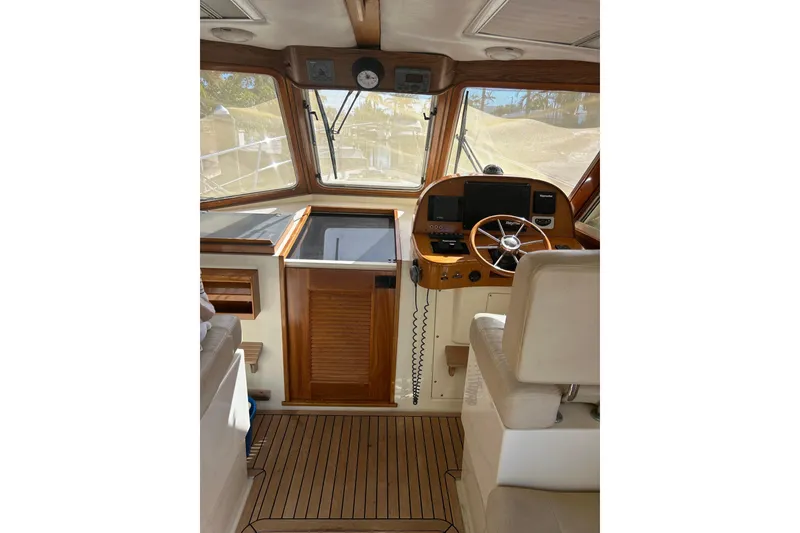 Slide: The Image of Interior view of 2007 Legacy EXPRESS CRUISER helm with wooden accents and navigation equipment. - 9