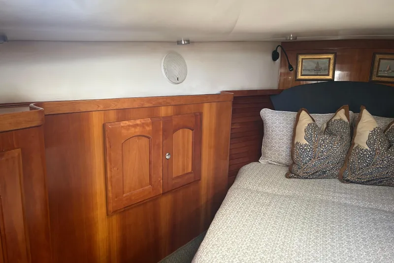 Slide: The Image of Interior of 2007 Legacy EXPRESS CRUISER with wooden cabinetry and decorative pillows. - 23