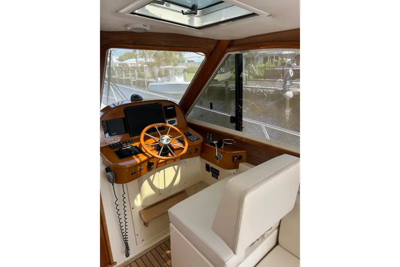 Slide: The Image of Interior of 2007 Legacy EXPRESS CRUISER with wooden helm and modern navigation equipment. - 3