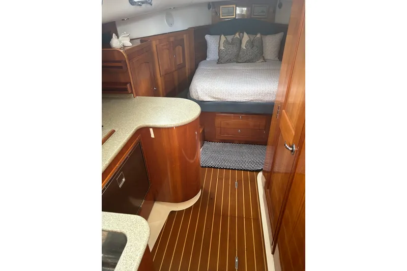 Slide: The Image of Luxurious 2007 Legacy EXPRESS CRUISER cabin with elegant wood finish and cozy bedding. - 19