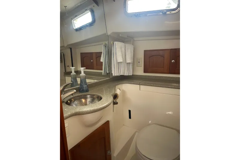 Slide: The Image of 2007 Legacy EXPRESS CRUISER bathroom with sink, mirror, and storage cabinets. - 30