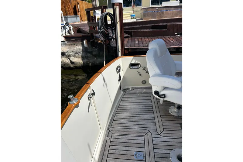 Slide: The Image of 2007 Legacy EXPRESS CRUISER boat deck with white seating and wooden accents. - 29