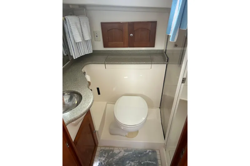 Slide: The Image of Bathroom interior of 2007 Legacy EXPRESS CRUISER with sink, toilet, and storage cabinets. - 28