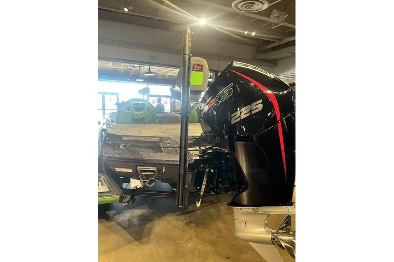 Slide: The Image of 2026 Ranger Z519R boat with powerful 225 horsepower engine displayed indoors. - 2