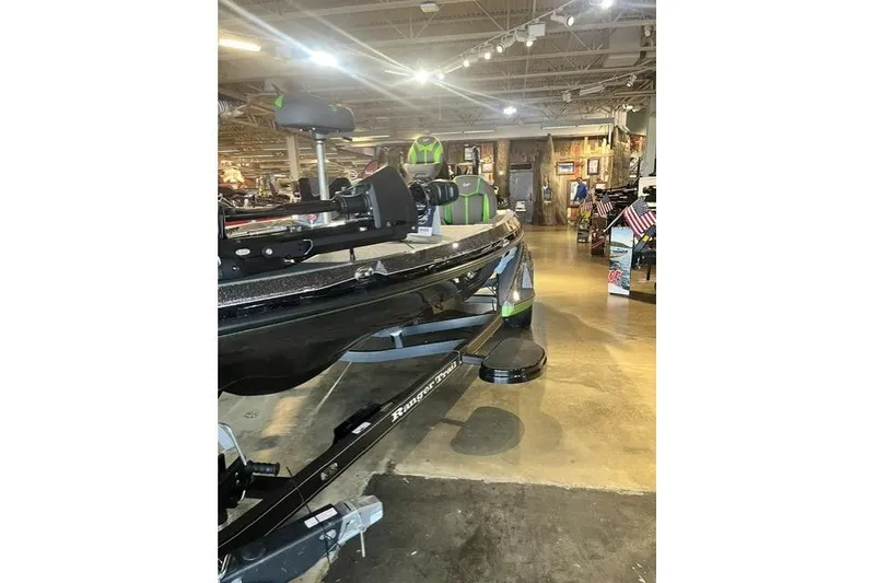 Slide: The Image of 2026 Ranger Z519R boat displayed in a showroom with bright lighting. - 8