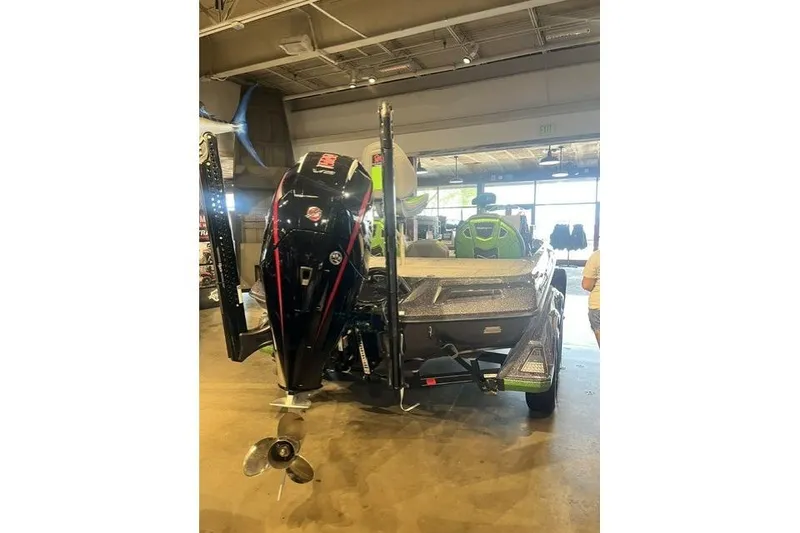 Slide: The Image of 2026 Ranger Z519R boat displayed indoors with visible motor and seating. - 3
