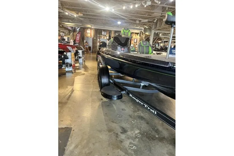 Slide: The Image of 2026 Ranger Z519R boat displayed indoors, featuring sleek design and vibrant green accents. - 6