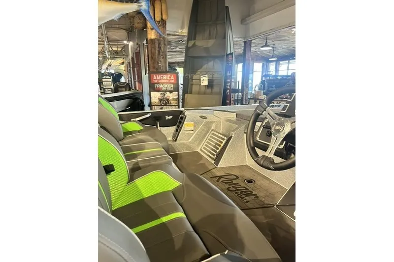 Slide: The Image of 2026 Ranger Z519R boat interior with green-accented seats and steering wheel in showroom. - 4