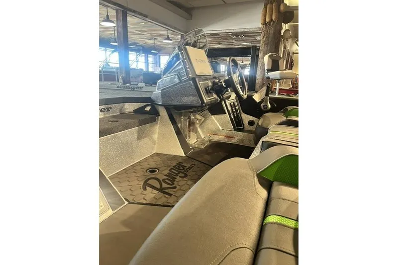The Image of 2026 Ranger Z519R boat interior with steering wheel and seating in showroom. - 1