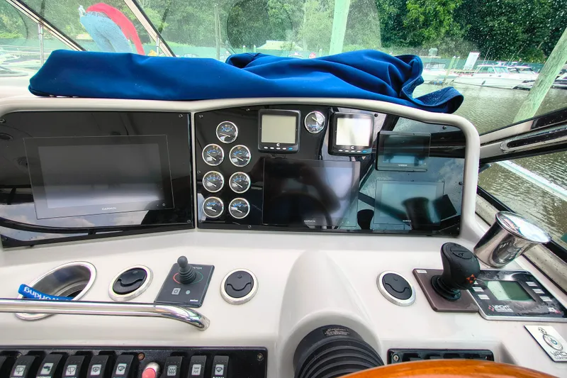 Slide: The Image of Control panel of a 2005 Formula 48 Yacht with navigation screens and gauges. - 9