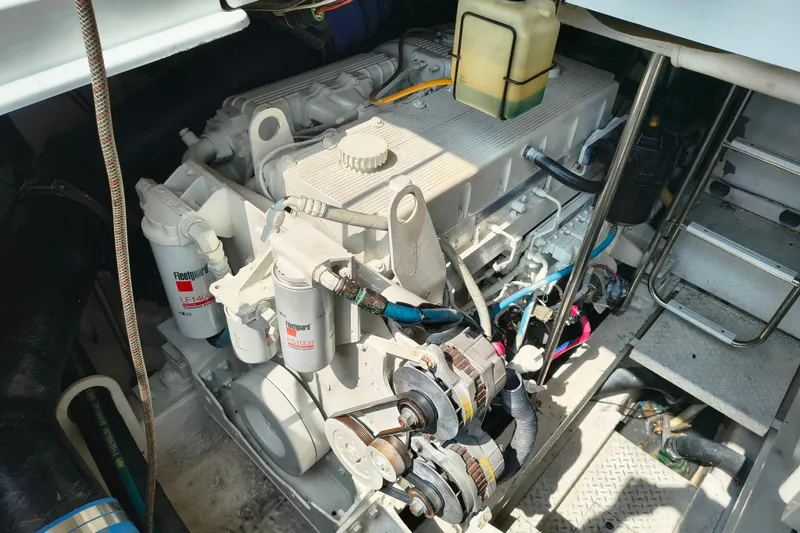 Slide: The Image of Engine compartment of a 2005 Formula 48 Yacht, showcasing mechanical components and filters. - 23