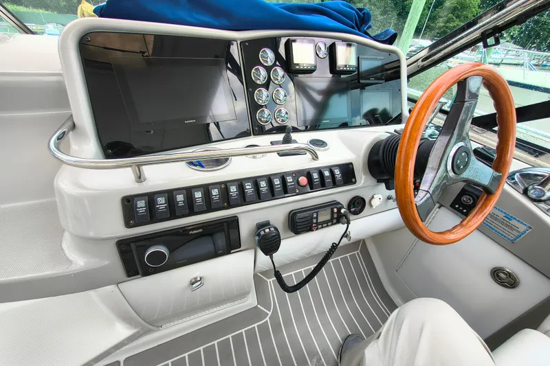 Slide: The Image of Helm of 2005 Formula 48 Yacht with wooden steering wheel and modern navigation controls. - 10