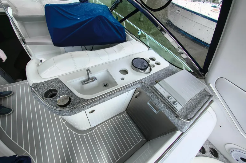 Slide: The Image of Interior view of a 2005 Formula 48 Yacht featuring a sleek kitchenette with sink and seating. - 7