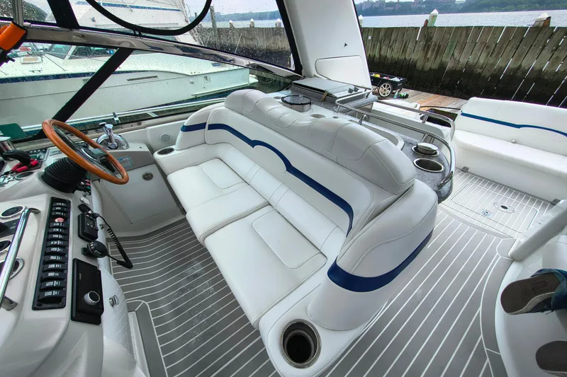 Slide: The Image of Luxurious interior of a 2005 Formula 48 Yacht with white seating and modern controls. - 8