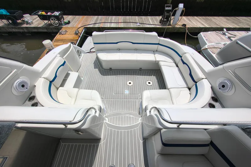 Slide: The Image of 2005 Formula 48 Yacht cockpit with white seating and gray flooring, dockside view. - 4