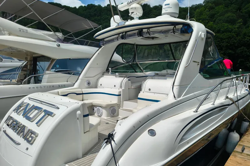 Slide: The Image of 2005 Formula 48 Yacht docked, featuring sleek design and spacious seating area. - 3