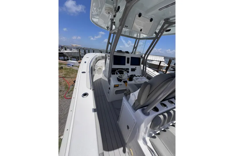 Slide: The Image of 2020 Cape Horn 32XS boat interior with helm, seats, and navigation equipment. - 4