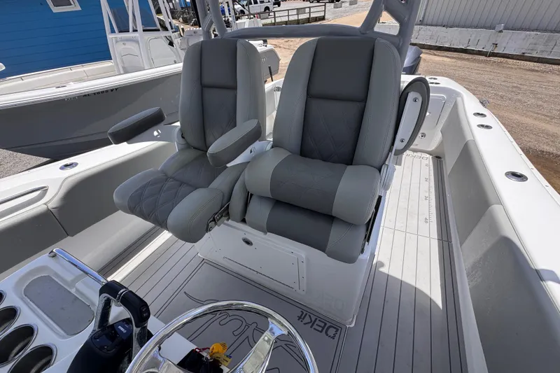 Slide: The Image of 2020 Cape Horn 32XS boat interior with dual gray captain's chairs and steering console. - 11