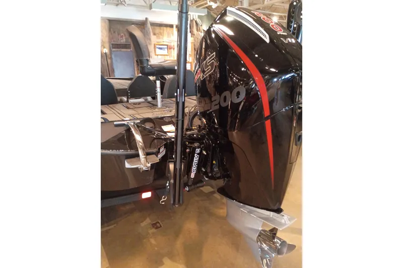 Slide: The Image of 2026 Tracker Savage 215 boat with powerful black and red outboard motor. - 16