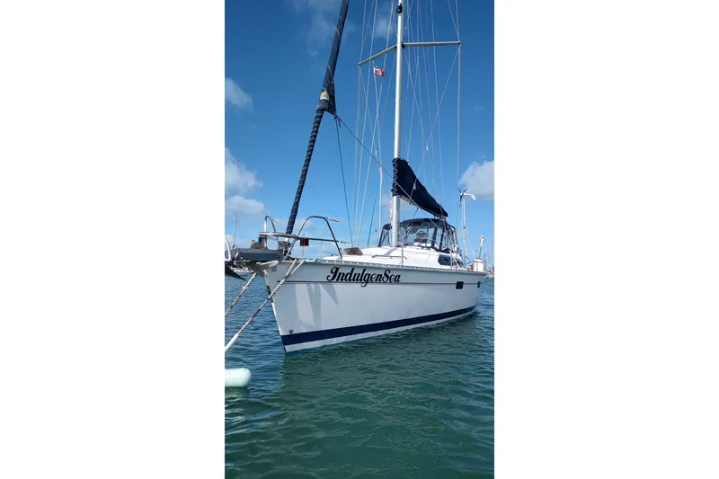 Slide: The Image of Sailboat "IndulgenSea" on water, Bass Hunter Passage 1994 model, clear sky background. - 9