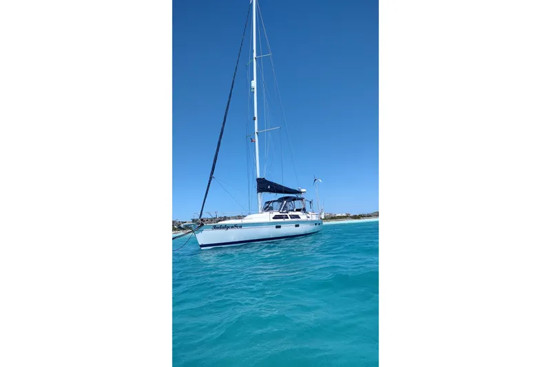 Slide: The Image of Sailboat "IndigoSea" on turquoise water, Bass Hunter Passage 1994 model, clear blue sky. - 7