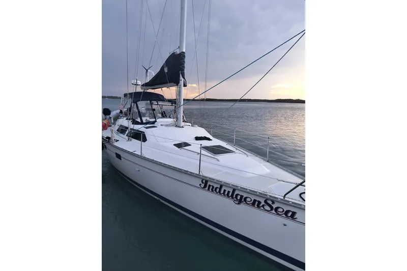 The Image of Sailboat "IndulgenSea" on water at sunset, Bass Hunter Passage 1994 model. - 5