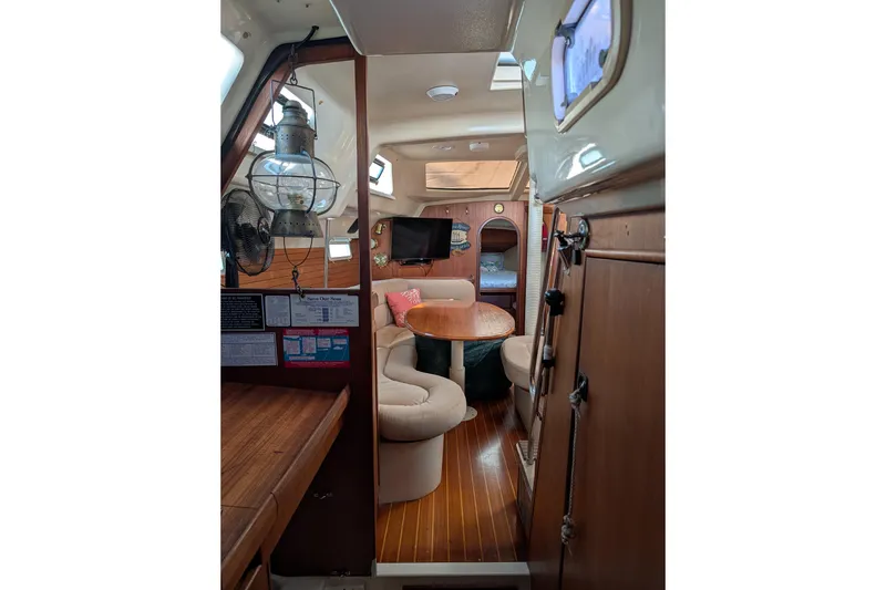 Slide: The Image of Cozy 1994 Bass Hunter Passage yacht interior with dining area and wooden finishes. - 19