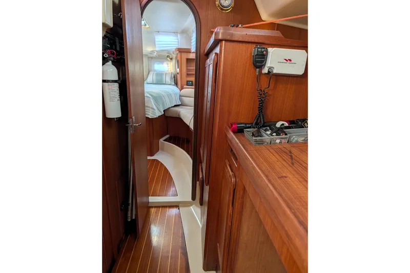 Slide: The Image of Interior of a 1994 Bass Hunter Passage boat, featuring wood paneling and a cozy cabin. - 15