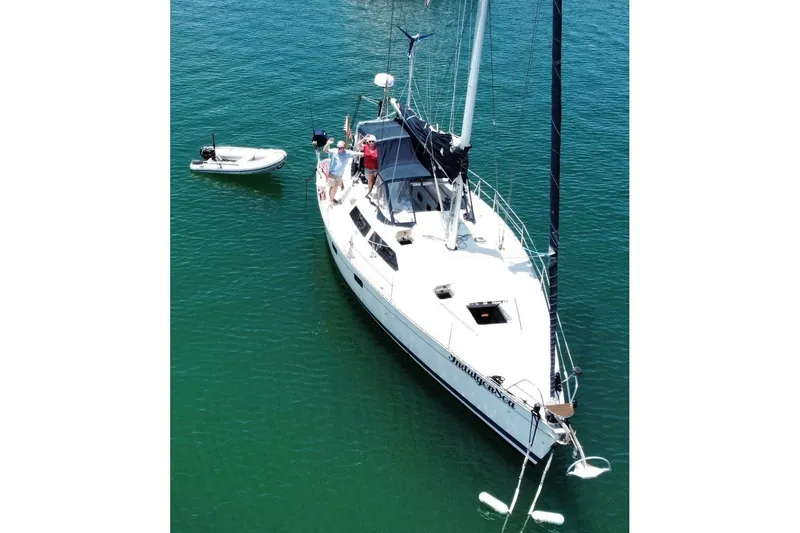 Slide: The Image of Sailboat "Bass Hunter Passage" 1994 on calm water with people onboard. - 1