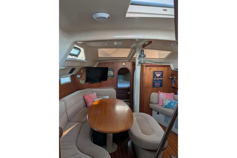 Slide: The Image of Interior of a 1994 Bass Hunter Passage boat with cozy seating and wooden table. - 20