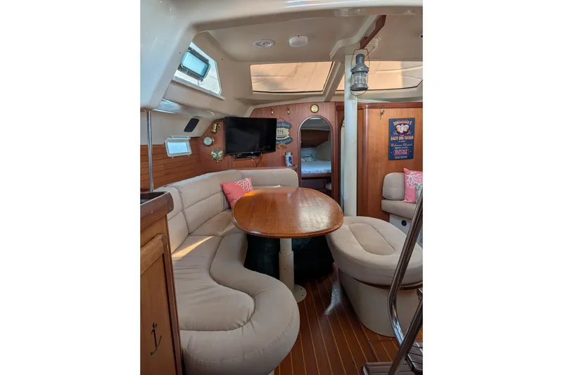 Slide: The Image of Cozy 1994 Bass Hunter Passage yacht interior with seating, table, and decor. - 18