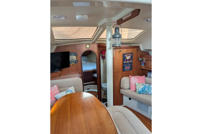 Slide: The Image of Cozy 1994 Bass Hunter Passage boat interior with seating, table, and decor. - 21