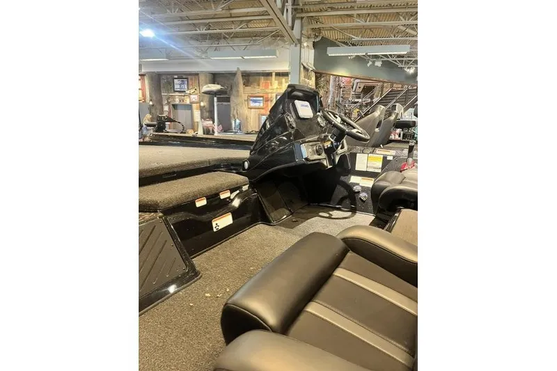 Slide: The Image of 2026 Nitra Boats Z20XL interior with steering console and seating in showroom. - 9
