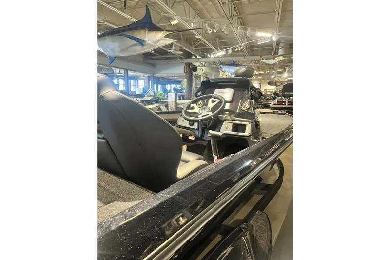 Slide: The Image of 2026 Nitra Boats Z20XL interior with steering wheel and dashboard in showroom. - 2