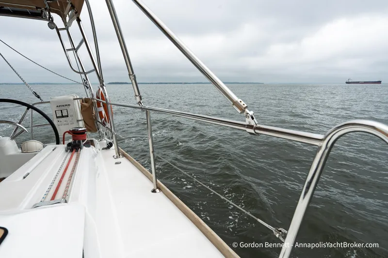 Slide: The Image of 2015 Jeanneau Sun Odyssey 439 sailing on open water under cloudy skies. - 26