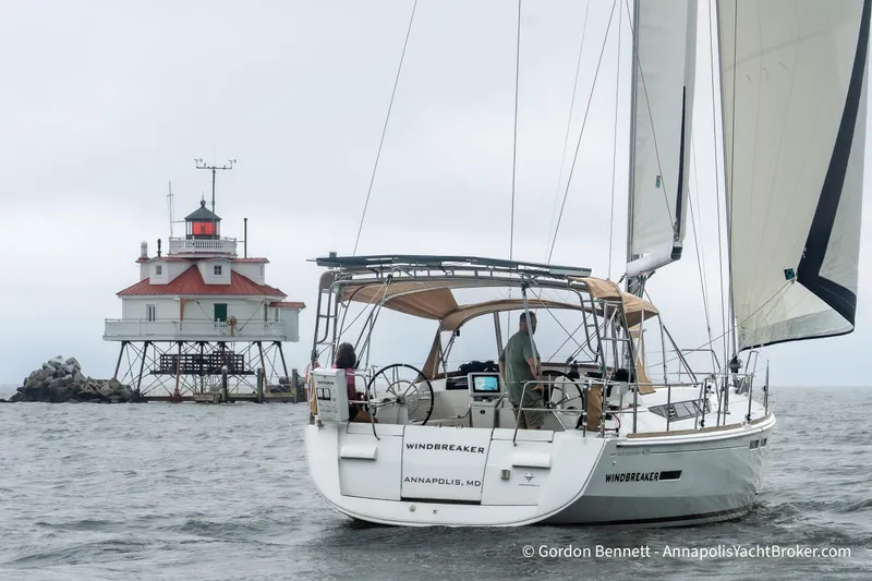 Slide: The Image of Sailboat Jeanneau Sun Odyssey 439, 2015, near a lighthouse on a cloudy day. - 75