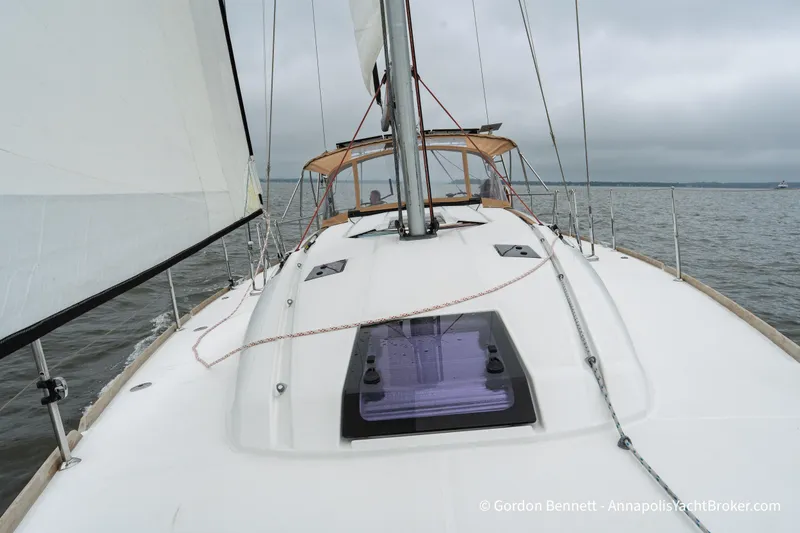 Slide: The Image of Sailing Jeanneau Sun Odyssey 439, 2015 model, on open water under cloudy skies. - 16