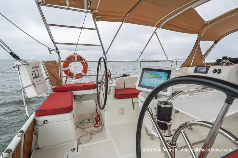 Slide: The Image of Cockpit of 2015 Jeanneau Sun Odyssey 439 sailboat with navigation equipment and ocean view. - 25