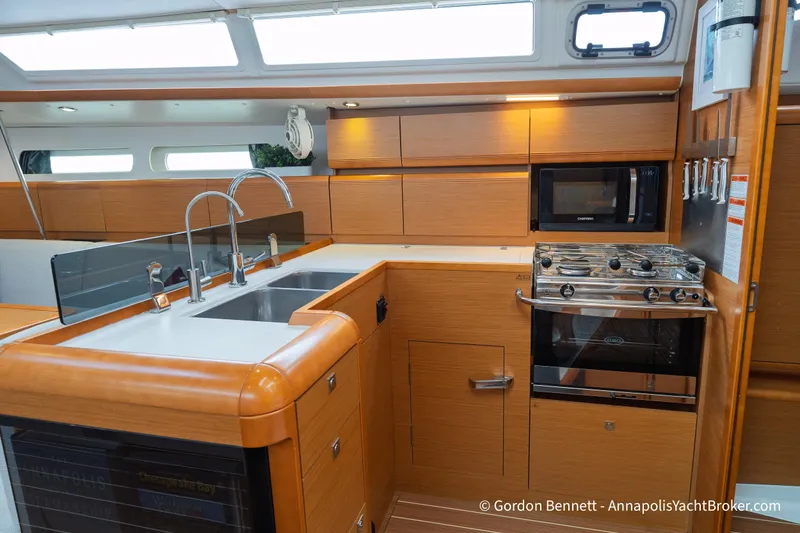 Slide: The Image of Interior of 2015 Jeanneau Sun Odyssey 439 yacht kitchen with modern appliances and wood finish. - 44