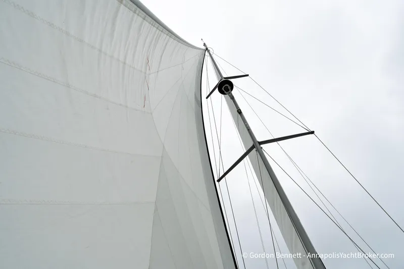 Slide: The Image of Sail of a 2015 Jeanneau Sun Odyssey 439 yacht against a cloudy sky. - 12