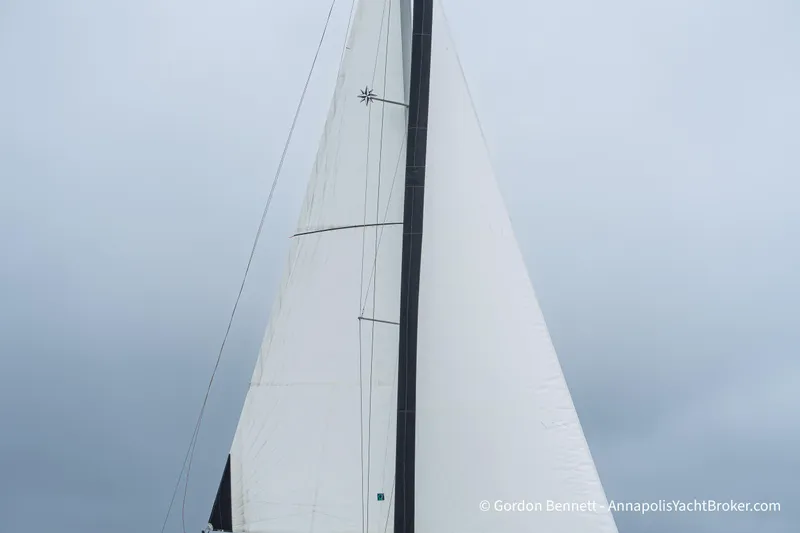 Slide: The Image of Sail of a 2015 Jeanneau Sun Odyssey 439 yacht against a cloudy sky. - 13
