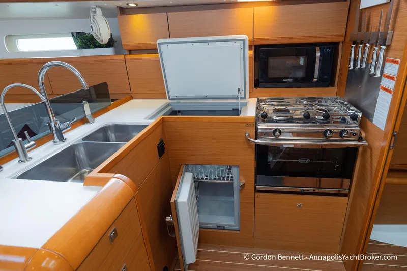 Slide: The Image of Modern kitchen in 2015 Jeanneau Sun Odyssey 439 yacht with stove, sink, and fridge. - 49