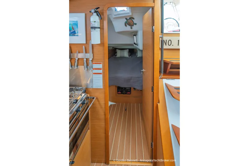 Slide: The Image of Interior view of 2015 Jeanneau Sun Odyssey 439 yacht cabin with wooden finish. - 51