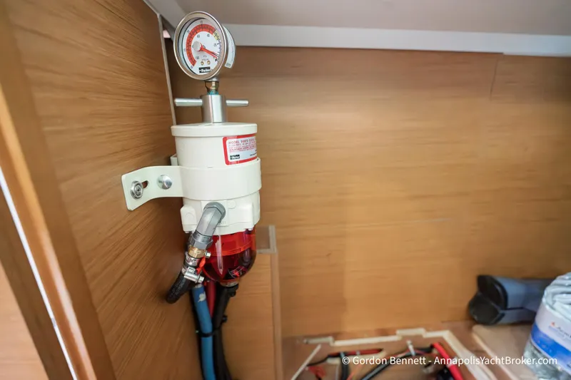 Slide: The Image of Fuel filter system inside 2015 Jeanneau Sun Odyssey 439 yacht, mounted on wooden panel. - 73