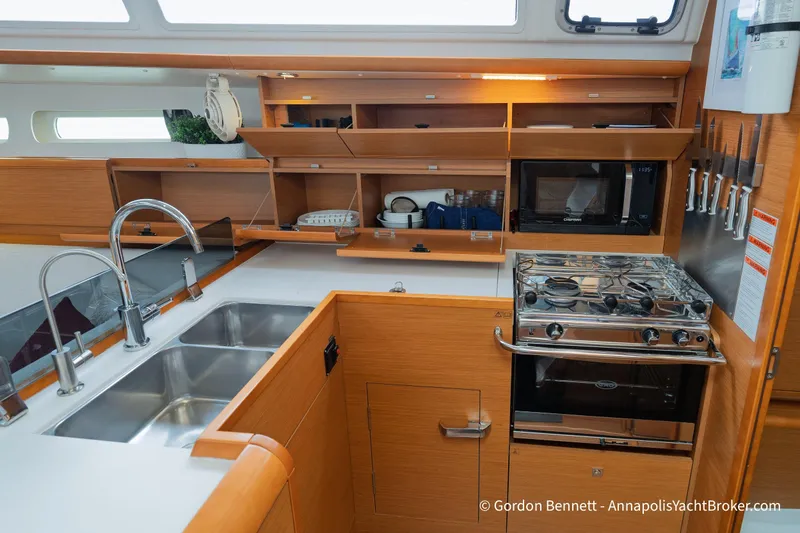 Slide: The Image of Modern kitchen in 2015 Jeanneau Sun Odyssey 439 yacht with stove, sink, and storage. - 50