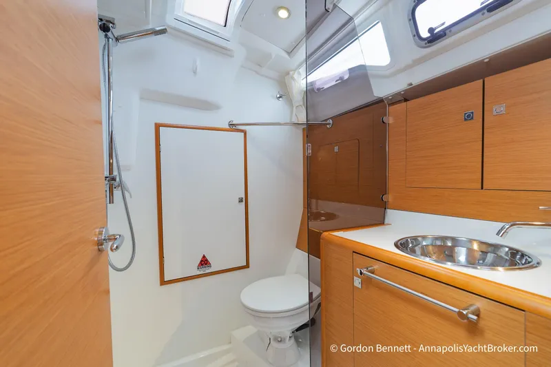 Slide: The Image of Interior of 2015 Jeanneau Sun Odyssey 439 yacht bathroom with modern fixtures and wood cabinetry. - 54